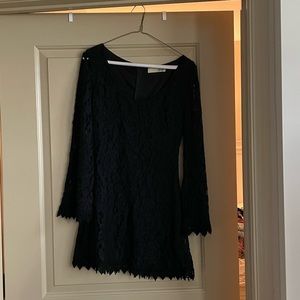 Short fitted black long-sleeve mini dress with lovely lace detailing